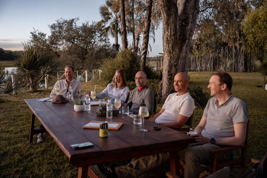 Dinner at a long table outdoors in Maun